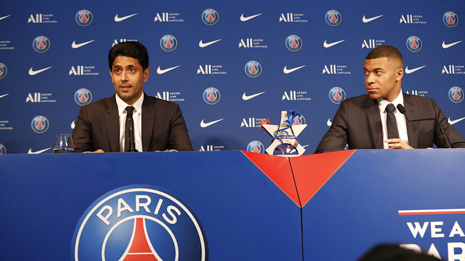 Nasser Al-Khelaifi (left) and Kylian Mbappé sitting together.
