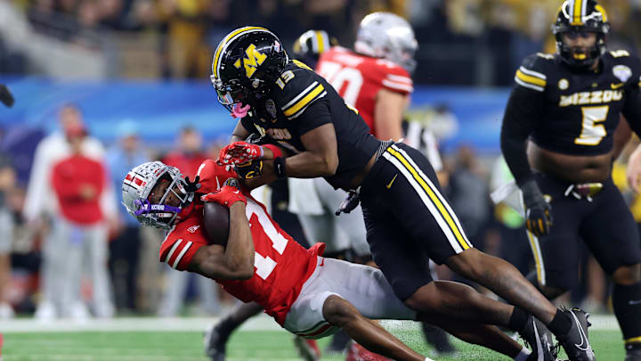Dec 29, 2023; Arlington, TX, USA; Ohio State Buckeyes wide receiver Carnell Tate (17) is tackled by Missouri Tigers defensive back Daylan Carnell (13) in the first half at AT&T Stadium. Mandatory Credit: Tim Heitman-USA TODAY Sports
