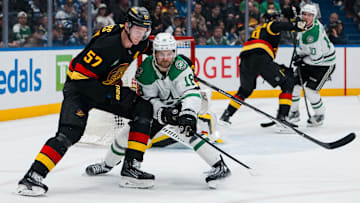 Mar 9, 2025; Vancouver, British Columbia, CAN; Vancouver Canucks defenseman Tyler Myers (57) battles with Dallas Stars forward Sam Steel (18) in the third period at Rogers Arena. Mandatory Credit: Bob Frid-Imagn Images