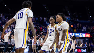 Jan 14, 2025; Baton Rouge, Louisiana, USA;  LSU Tigers forward Daimion Collins (10) and guard Cam Carter (5) and guard Jordan Sears (1) celebrate a victory over the Arkansas Razorbacks at Pete Maravich Assembly Center. Mandatory Credit: Stephen Lew-Imagn Images