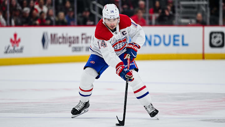Mar 19, 2026; Detroit, Michigan, USA; Montreal Canadiens center Nick Suzuki (14) brings the puck up ice during the first period against the Detroit Red Wings at Little Caesars Arena. Mandatory Credit: Tim Fuller-Imagn Images