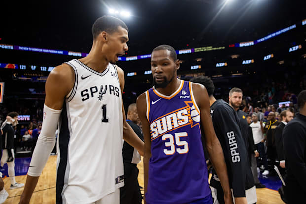 San Antonio Spurs center Victor Wembanyama (1) talks with Phoenix Suns forward Kevin Durant (35)