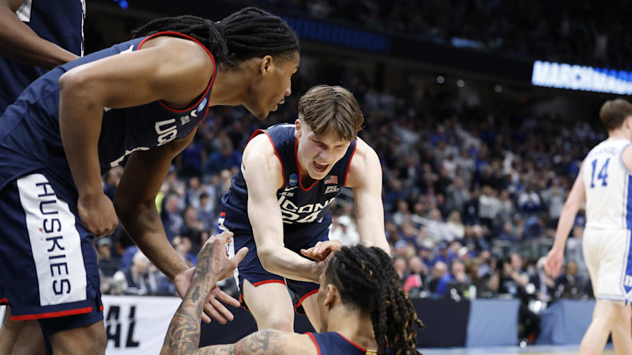 UConn Huskies guard Braylon Mullins helps UConn Huskies guard Solo Ball off the court against the Duke Blue Devils.