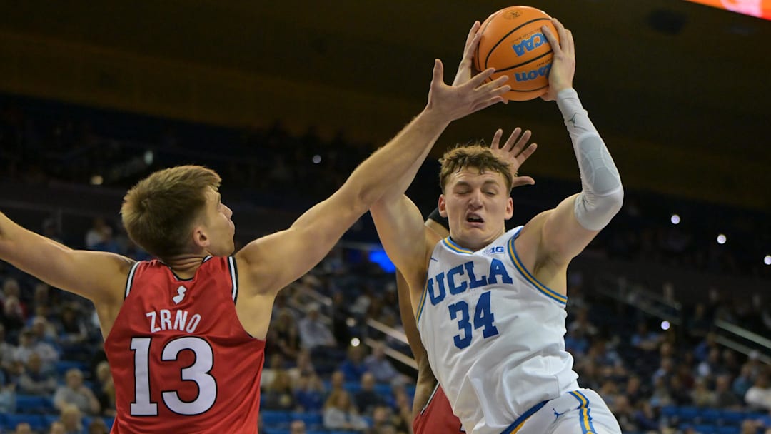Feb 3, 2026; Los Angeles, California, USA; UCLA Bruins forward Tyler Bilodeau (34) rebounds in front of Rutgers Scarlet Knights guard Harun Zrno (13) in the second half at Pauley Pavilion presented by Wescom Financial. Mandatory Credit: Jayne Kamin-Oncea-Imagn Images Feb 3, 2026; Los Angeles, California, USA; UCLA Bruins forward Tyler Bilodeau (34) rebounds in front of Rutgers Scarlet Knights guard Harun Zrno (13) in the second half at Pauley Pavilion presented by Wescom Financial. Mandatory Credit: Jayne Kamin-Oncea-Imagn Images