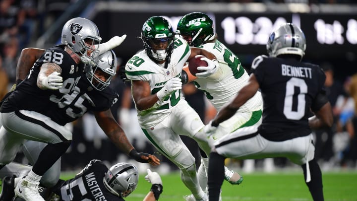 Nov 12, 2023; Paradise, Nevada, USA; New York Jets running back Breece Hall (20) runs the ball against Las Vegas Raiders defensive end Maxx Crosby (98) and cornerback Jakorian Bennett (0) during the first half at Allegiant Stadium. Mandatory Credit: Gary A. Vasquez-USA TODAY Sports