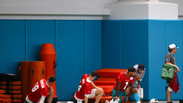 Jul 24, 2024; Miami Gardens, FL, USA; Miami Dolphins head coach Mike McDaniel talks to quarterback Tua Tagovailoa (1) during training camp at Baptist Health Training Complex. 