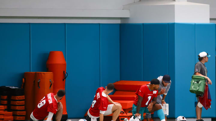 Jul 24, 2024; Miami Gardens, FL, USA; Miami Dolphins head coach Mike McDaniel talks to quarterback Tua Tagovailoa (1) during training camp at Baptist Health Training Complex. 