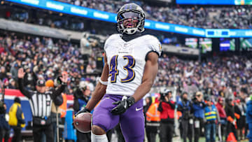 Dec 15, 2024; East Rutherford, New Jersey, USA; Baltimore Ravens running back Justice Hill (43) scores a touchdown reception during the second half against the New York Giants at MetLife Stadium. Mandatory Credit: Vincent Carchietta-Imagn Images