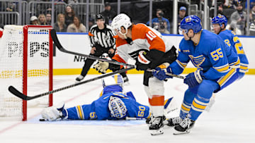 Nov 30, 2024; St. Louis, Missouri, USA;  St. Louis Blues goaltender Jordan Binnington (50) and defenseman Colton Parayko (55) defend the net against Philadelphia Flyers right wing Bobby Brink (10) during the third period at Enterprise Center. Mandatory Credit: Jeff Curry-Imagn Images
