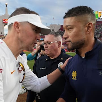 Nov 30, 2024; Los Angeles, California, USA; Southern California Trojans head coach Lincoln Riley and Notre Dame Fighting Irish head coach Marcus Freeman shake hands after the game at United Airlines Field at Los Angeles Memorial Coliseum. 