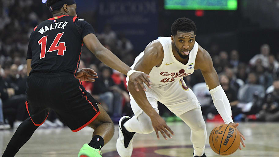 Cavaliers guard Donovan Mitchell dribbles beside Raptors guard Ja’Kobe Walter in Game 5.