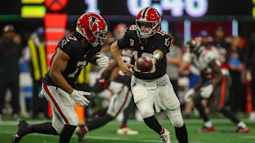 Oct 3, 2024; Atlanta, Georgia, USA; Atlanta Falcons quarterback Kirk Cousins (18) hands the ball off to running back Bijan Robinson (7) against the Tampa Bay Buccaneers in the first quarter at Mercedes-Benz Stadium. Mandatory Credit: Brett Davis-Imagn Images