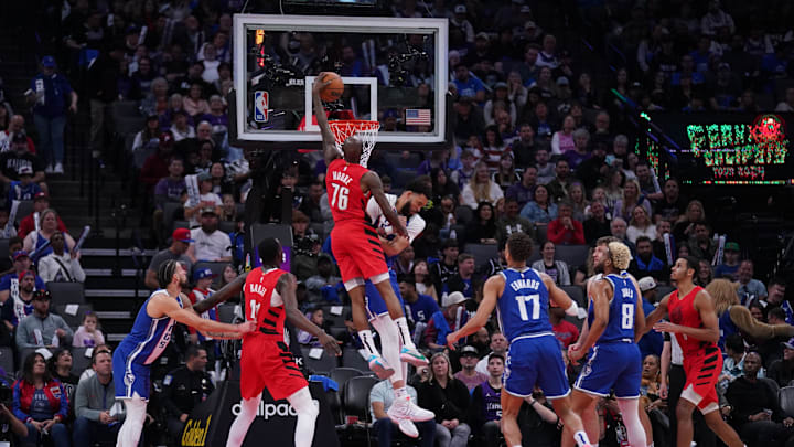 Apr 14, 2024; Sacramento, California, USA; Portland Trail Blazers guard Taze Moore (76) dunks over Sacramento Kings center JaVale McGee (00) in the fourth quarter at the Golden 1 Center. Mandatory Credit: Cary Edmondson-Imagn Images