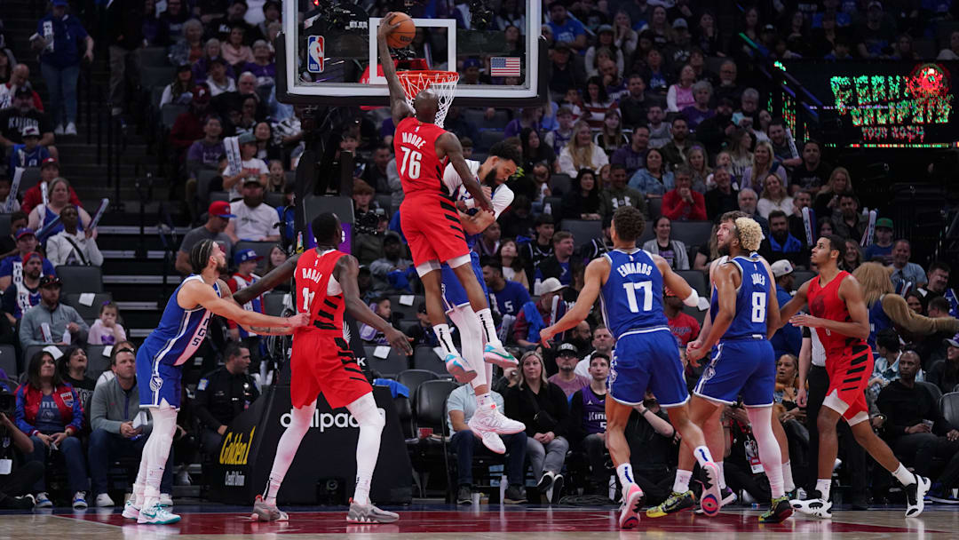 Apr 14, 2024; Sacramento, California, USA; Portland Trail Blazers guard Taze Moore (76) dunks over Sacramento Kings center JaVale McGee (00) in the fourth quarter at the Golden 1 Center. Mandatory Credit: Cary Edmondson-Imagn Images