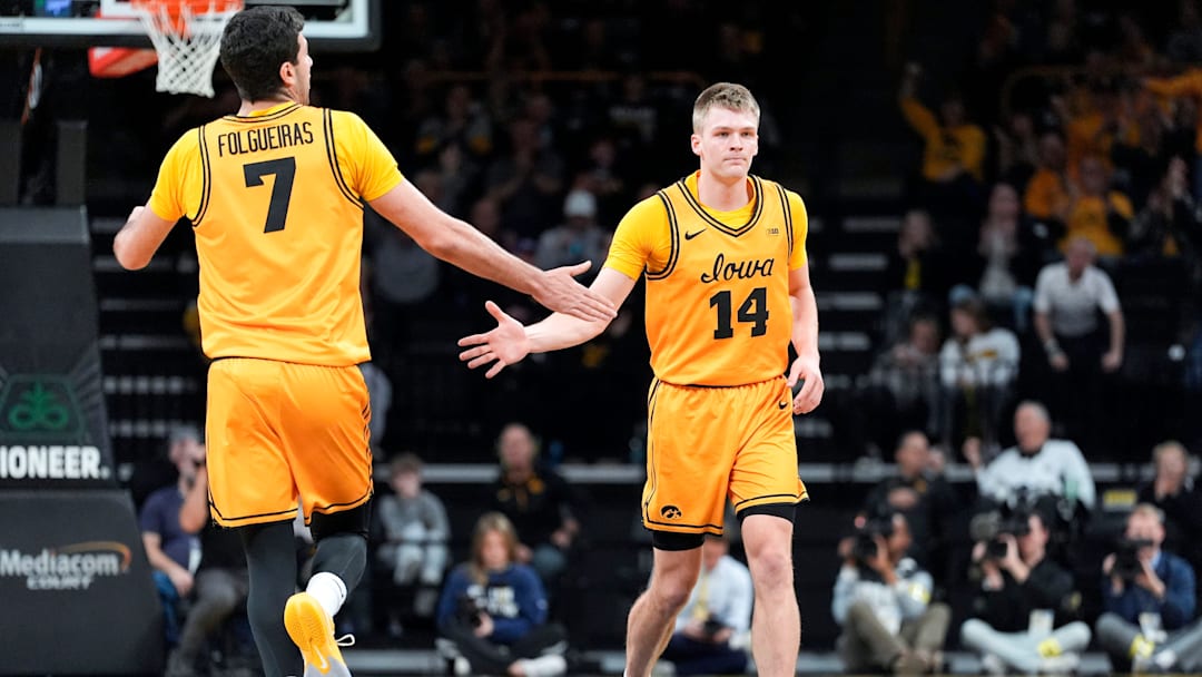 Iowa forward Alvaro Folgueiras (7) high-fives Iowa guard Bennett Stirtz (14) during a basketball game against the Maryland Terrapins Dec. 6, 2025 at Carver-Hawkeye Arena in Iowa City, Iowa. Iowa forward Alvaro Folgueiras (7) high-fives Iowa guard Bennett Stirtz (14) during a basketball game against the Maryland Terrapins Dec. 6, 2025 at Carver-Hawkeye Arena in Iowa City, Iowa.
