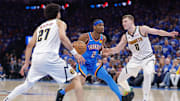 May 18, 2025; Oklahoma City, Oklahoma, USA; Oklahoma City Thunder guard Shai Gilgeous-Alexander (2) drives between guard Jamal Murray (27) and Denver Nuggets guard Christian Braun (0) in the second half during game seven of the second round for the 2025 NBA Playoffs at Paycom Center. Mandatory Credit: Alonzo Adams-Imagn Images