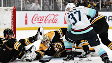 Nov 3, 2024; Boston, Massachusetts, USA; Boston Bruins goaltender Jeremy Swayman (1) makes a save on a shot made by Seattle Kraken center Yanni Gourde (37) during the second period at the TD Garden. Mandatory Credit: Brian Fluharty-Imagn Images
