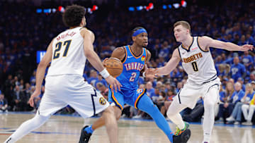 May 18, 2025; Oklahoma City, Oklahoma, USA; Oklahoma City Thunder guard Shai Gilgeous-Alexander (2) drives between guard Jamal Murray (27) and Denver Nuggets guard Christian Braun (0) in the second half during game seven of the second round for the 2025 NBA Playoffs at Paycom Center. Mandatory Credit: Alonzo Adams-Imagn Images