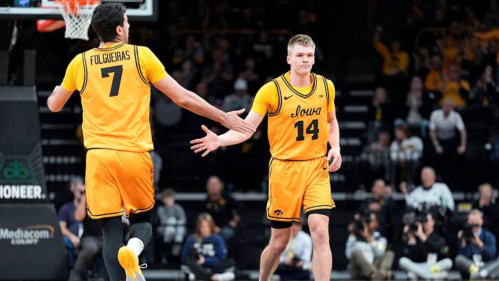 Iowa forward Alvaro Folgueiras (7) high-fives Iowa guard Bennett Stirtz (14) during a basketball game against the Maryland Terrapins Dec. 6, 2025 at Carver-Hawkeye Arena in Iowa City, Iowa.
