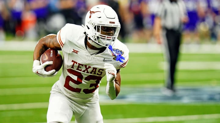 Jan 1, 2024; New Orleans, LA, USA; Texas Longhorns running back Jaydon Blue (23) runs the ball against the Washington Huskies in the 2024 Sugar Bowl college football playoff semifinal game at Caesars Superdome. Mandatory Credit: John David Mercer-USA TODAY Sports