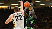 Nov 7, 2023; Iowa City, Iowa, USA; North Dakota Fighting Hawks forward B.J. Omot (20) shoots against Iowa Hawkeyes forward Patrick McCaffery (22) during the first half at Carver-Hawkeye Arena. Mandatory Credit: Jeffrey Becker-Imagn Images