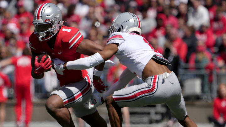 April 13, 2024; Columbus, Ohio, USA; 
Ohio State Buckeyes running back Quinshon Judkins (1) of the scarlet team is tagged by cornerback Davison Igbinosun (1) of the grey team during the first half of the LifeSports spring football game at Ohio Stadium on Saturday.