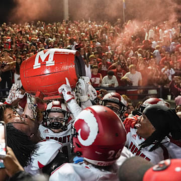 DuPont Manual celebrates with regaining the Barrel after the Crimsons beat rival Male 
