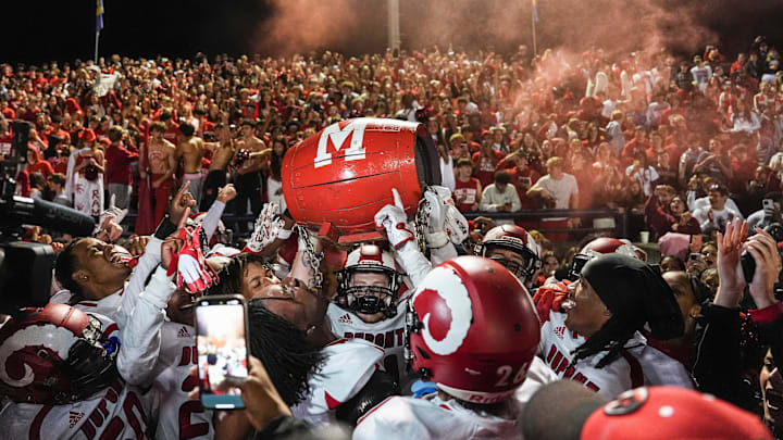 DuPont Manual celebrates with regaining the Barrel after the Crimsons beat rival Male 
