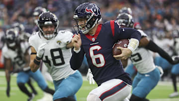 Jan 1, 2023; Houston, Texas, USA; Houston Texans quarterback Jeff Driskel (6) runs with the ball as Jacksonville Jaguars linebacker Chad Muma (48) attempts to make a tackle during the second quarter at NRG Stadium.
