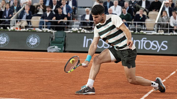 Carlos Alcaraz of Spain returns a shot during his match against Lorenzo Musetti of Italy during the 2025 French Open