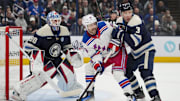 Feb 8, 2025; Columbus, Ohio, USA; Columbus Blue Jackets goaltender Elvis Merzlikins (90) defends the net as New York Rangers center Vincent Trocheck (16) skates against Columbus Blue Jackets defenseman Jack Johnson (3) in the first period at Nationwide Arena. Mandatory Credit: Aaron Doster-Imagn Images