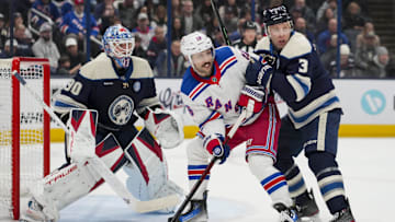 Feb 8, 2025; Columbus, Ohio, USA; Columbus Blue Jackets goaltender Elvis Merzlikins (90) defends the net as New York Rangers center Vincent Trocheck (16) skates against Columbus Blue Jackets defenseman Jack Johnson (3) in the first period at Nationwide Arena. Mandatory Credit: Aaron Doster-Imagn Images
