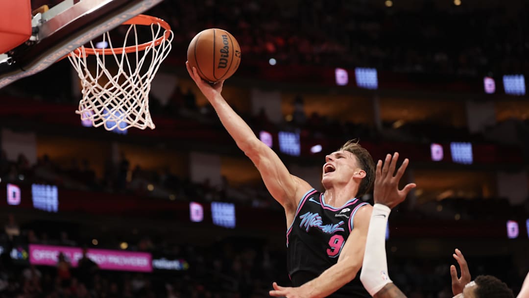 Mar 21, 2026; Houston, Texas, USA;  Miami Heat guard Pelle Larsson (9) scores a basket against Houston Rockets forward Jabari Smith Jr. (10) in the second half at Toyota Center. Mandatory Credit: Thomas Shea-Imagn Images