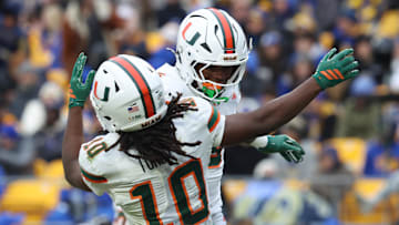 Nov 29, 2025; Pittsburgh, Pennsylvania, USA;  Miami Hurricanes wide receiver Malachi Toney (10) and running back CharMar Brown (right) celebrate a touchdown against the Pittsburgh Panthers during the third quarter at Acrisure Stadium. Mandatory Credit: Charles LeClaire-Imagn Images