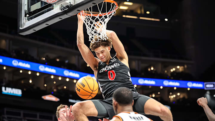 Mar 11, 2025; Kansas City, MO, USA; Cincinnati Bearcats guard Dan Skillings Jr. (0) dunks during the second half against the Oklahoma State Cowboys at T-Mobile Center. Mandatory Credit: William Purnell-Imagn Images