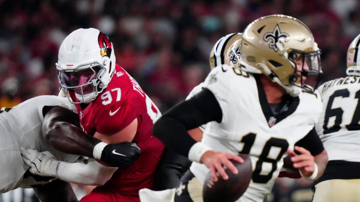 Cardinals defensive lineman Cameron Thomas (97) tries to shed a block and put pressure on Saints quarterback Spencer Rattler (18) during a game at State Farm Stadium in Glendale, Ariz., on Saturday, Aug. 10, 2024.