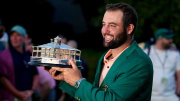 Apr 14, 2024; Augusta, Georgia, USA; Scottie Scheffler holds up his trophy at the green jacket ceremony after winning the Masters Tournament. Mandatory Credit: Adam Cairns-USA TODAY Network