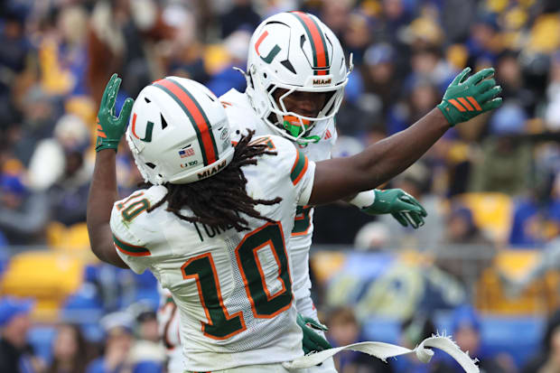 Miami wide receiver Malachi Toney and running back CharMar Brown celebrate a touchdown against Pitt.