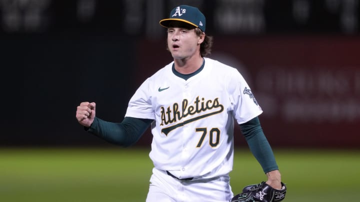 Aug 21, 2024; Oakland, California, USA; Oakland Athletics relief pitcher J.T. Ginn (70) reacts after striking out the side in his MLB debut against the Tampa Bay Rays /during the eighth inning at Oakland-Alameda County Coliseum. Mandatory Credit: Darren Yamashita-USA TODAY Sports