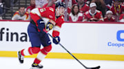 Apr 28, 2025; Sunrise, Florida, USA; Florida Panthers defenseman Niko Mikkola (77) controls the puck against the Tampa Bay Lightning during the first period in game four of the first round of the 2025 Stanley Cup Playoffs at Amerant Bank Arena. Mandatory Credit: Rich Storry-Imagn Images