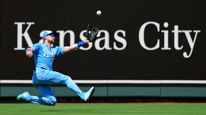 Jul 5, 2026: Kansas City Royals center fielder Lane Thomas (15) makes a sliding catch during the fifth inning against the Philadelphia Phillies at Kauffman Stadium. Credit: Jay Biggerstaff-Imagn Images
