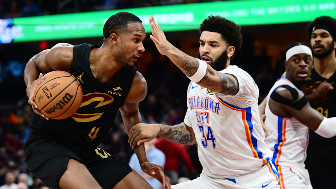 Jan 19, 2026; Cleveland, Ohio, USA; Cleveland Cavaliers center Evan Mobley (4) drives to the basket against Oklahoma City Thunder guard Kenrich Williams (34) during the second half at Rocket Arena. Mandatory Credit: Ken Blaze-Imagn Images