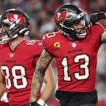 Jan 12, 2025; Tampa, Florida, USA; Tampa Bay Buccaneers wide receiver Mike Evans (13) celebrates after a touchdown catch with tight end Cade Otton (88) during the second quarter of a NFC wild card playoff against the Washington Commanders at Raymond James Stadium. Mandatory Credit: Kim Klement Neitzel-Imagn Images