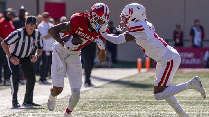 Oct 19, 2024; Bloomington, Indiana, USA; Indiana Hoosiers wide receiver E.J. Williams Jr. (7) gets stiff armed by Nebraska Cornhuskers defensive back Ceyair Wright (15) during the second quarter at Memorial Stadium. Mandatory Credit: Jacob Musselman-Imagn Images