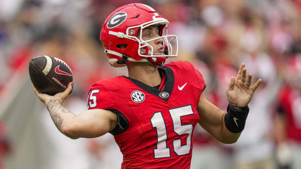 Georgia Bulldogs quarterback Carson Beck attempts a pass during a college football game in the SEC.