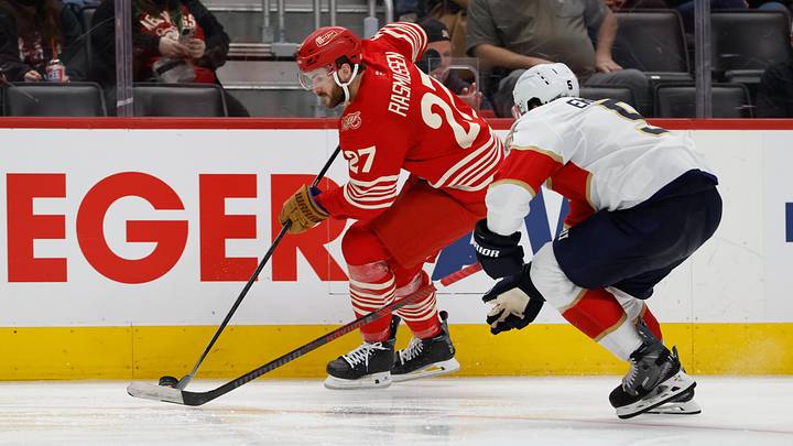 Mar 6, 2026; Detroit, Michigan, USA;  Detroit Red Wings center Michael Rasmussen (27) skates with the puck defended by Florida Panthers defenseman Aaron Ekblad (5) in the second period at Little Caesars Arena. Mandatory Credit: Rick Osentoski-Imagn Images