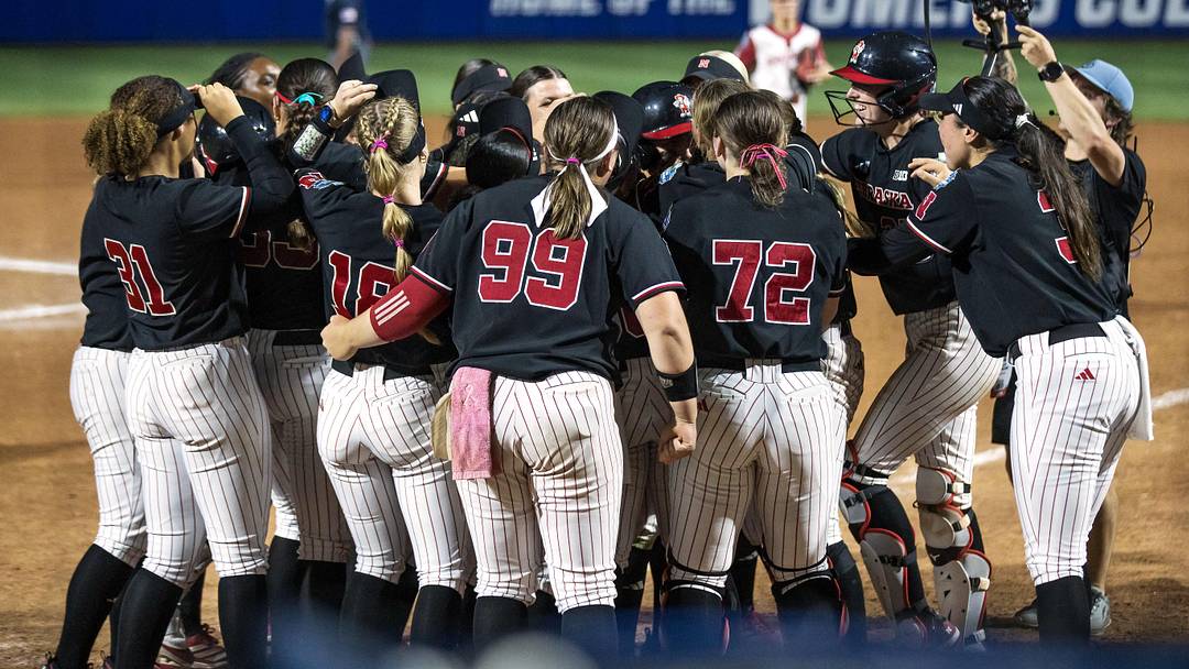 Nebraska Cornhuskers players celebrate after infielder Ava Kuszak (7) hit a two-run home run in the tenth inning to end the game against the Arkansas Razorbacks during the NCAA Women’s College World Series at Devon Park. 