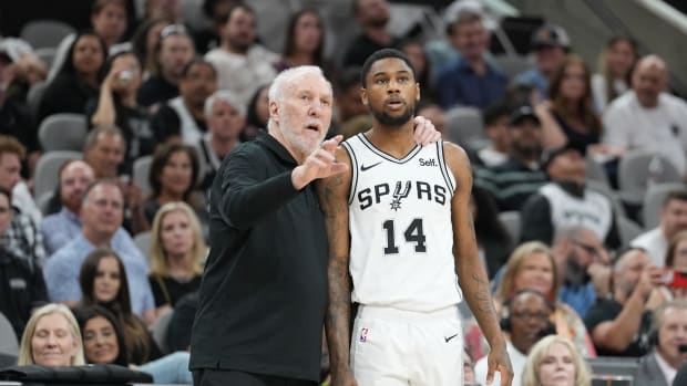 Mar 22, 2024; San Antonio, Texas, USA; San Antonio Spurs head coach Gregg Popovich talks with guard Blake Wesley (14).