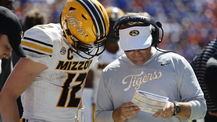 Oct 8, 2022; Gainesville, Florida, USA; Missouri Tigers head coach Eliah Drinkwitz and quarterback Brady Cook (12) talk against the Florida Gators during the second half at Ben Hill Griffin Stadium. Mandatory Credit: Kim Klement-USA TODAY Sports