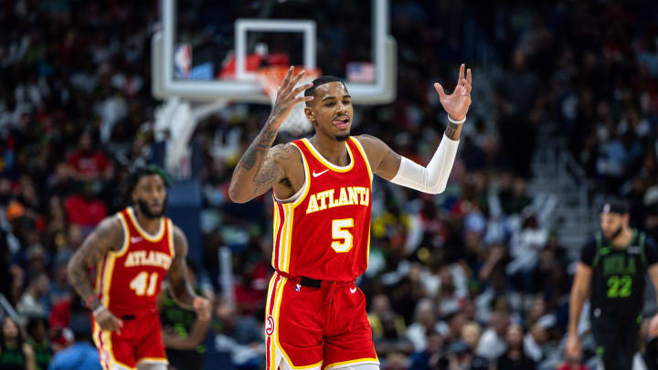 Nov 4, 2023; New Orleans, Louisiana, USA;  Atlanta Hawks guard Dejounte Murray (5) reacts to making a three point basket against New Orleans Pelicans guard Kira Lewis Jr. (13) during the second half at Smoothie King Center. Mandatory Credit: Stephen Lew-USA TODAY Sports
